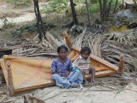 chidren on wreckage of their home, India
