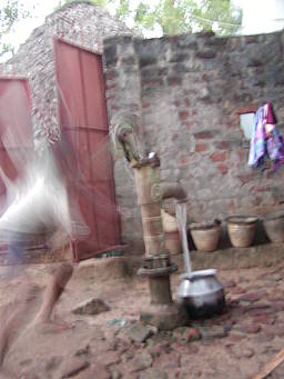boy pumping water