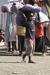 boy carrying blanket