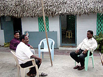 men seated in courtyard