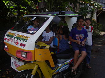 children in a motor-tricycle taxi